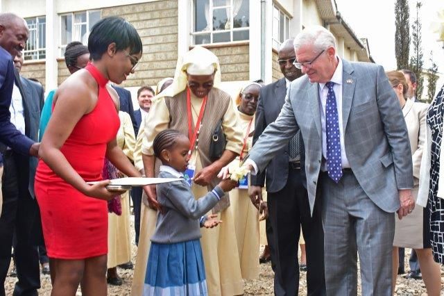 A nursery school girl and DOW Chemical Co. usher hand ribbon-cutting scissors to Gilbert Kaplan, U.S. Under Secretary of Commerce..jpg
