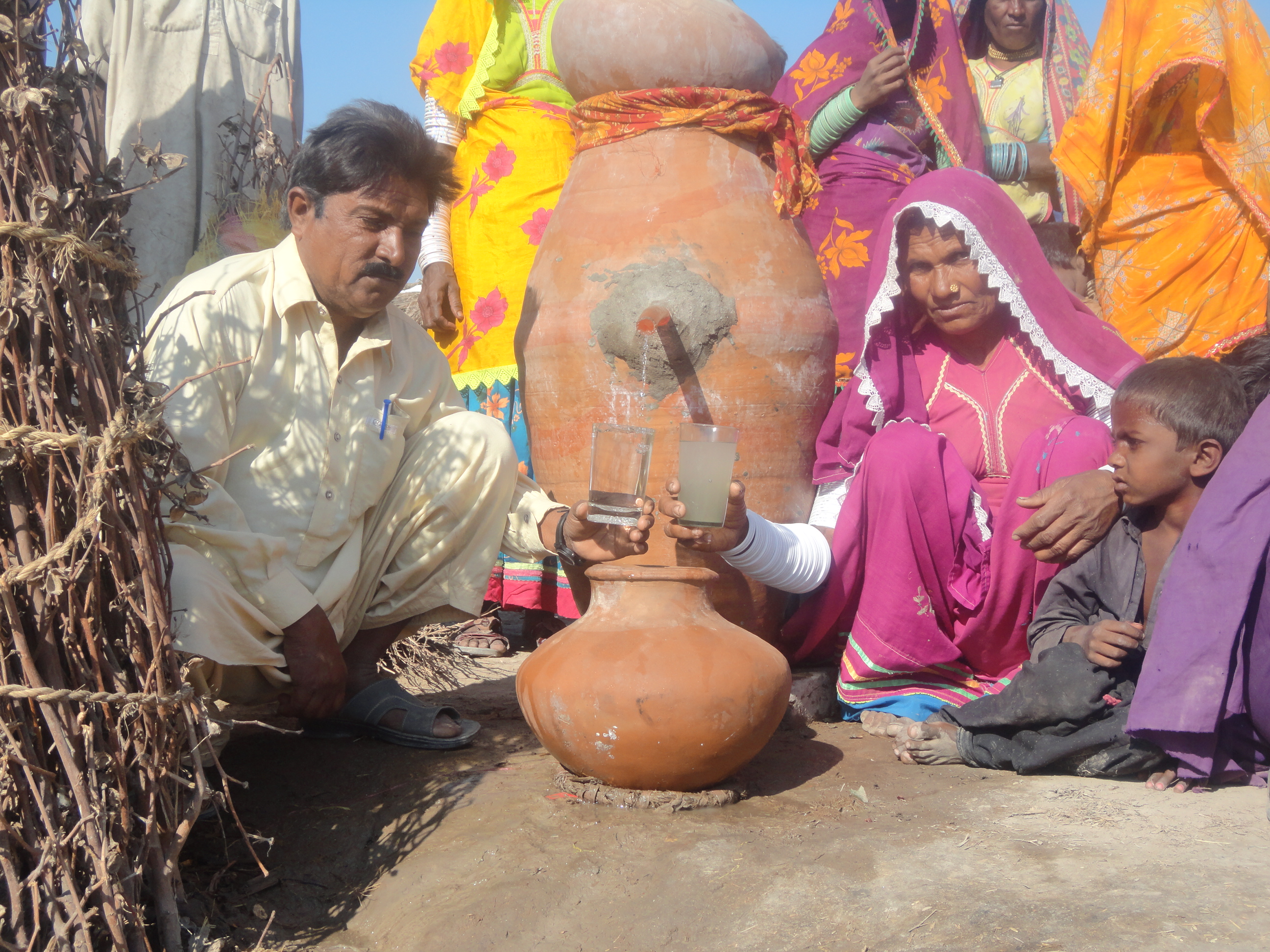 Mr &amp; Mrs. Bhomo Kohli near Tharri Matli city of Badin District Sind Pakistan, showing Nadi filtered water safe and clean fro drinking purpos...