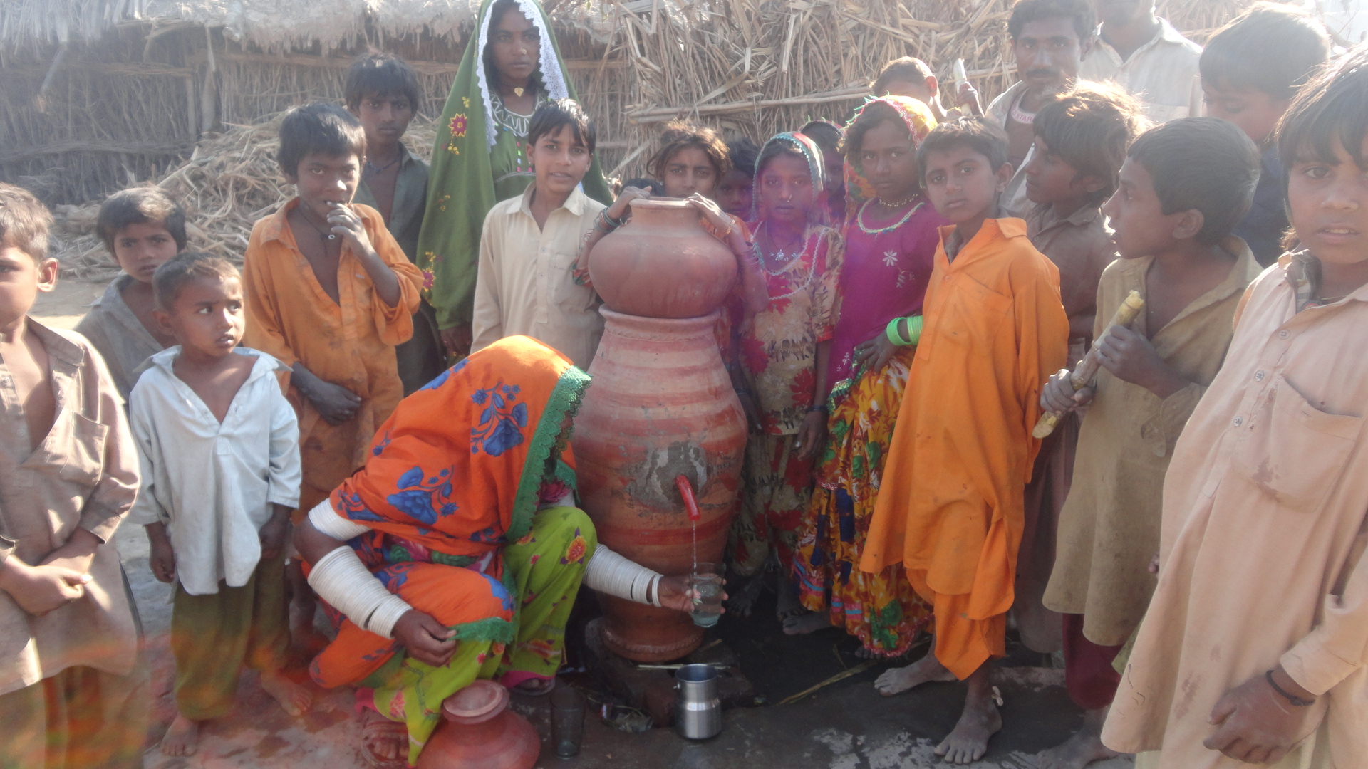 Mrs. Jeeti Chettan filling glass for water from Nadi filter Near Matli, Badin Pakistan. AHD non profit working in Pakistan since 2006-2007 on sa...